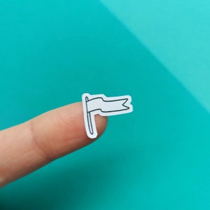 May include: A white sticker with a black outline of a flag waving in the wind.