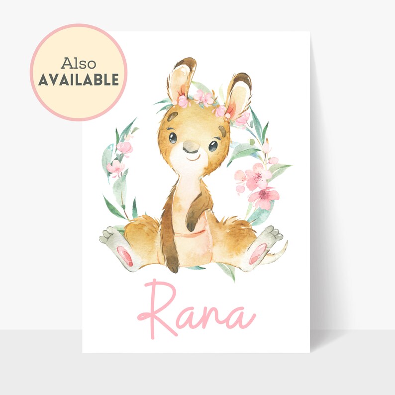 May include: A watercolour illustration of a kangaroo named Rana, sitting with a floral wreath and pink flowers. The kangaroo is light brown with a pink pouch and a flower crown. The text "Also Available" is in a pink circle.