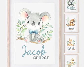 May include: Watercolor print featuring a cute koala bear with a blue bow tie, sitting on a branch. The print includes the name "Jacob" and "George" in a script font. Additional prints with animal illustrations and names are also shown.