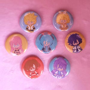 May include: A collection of seven round pinback buttons featuring anime-style character illustrations. The buttons showcase characters with various hair colors, including yellow, pink, blue, and purple, set against different colored backgrounds.