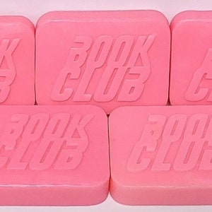 May include: Five pink soap bars with the text "BOOK CLUB" embossed on each bar.