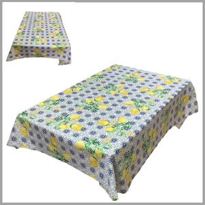 May include: White tablecloth with a lemon and blue tile pattern. The tablecloth is rectangular and has a scalloped edge.