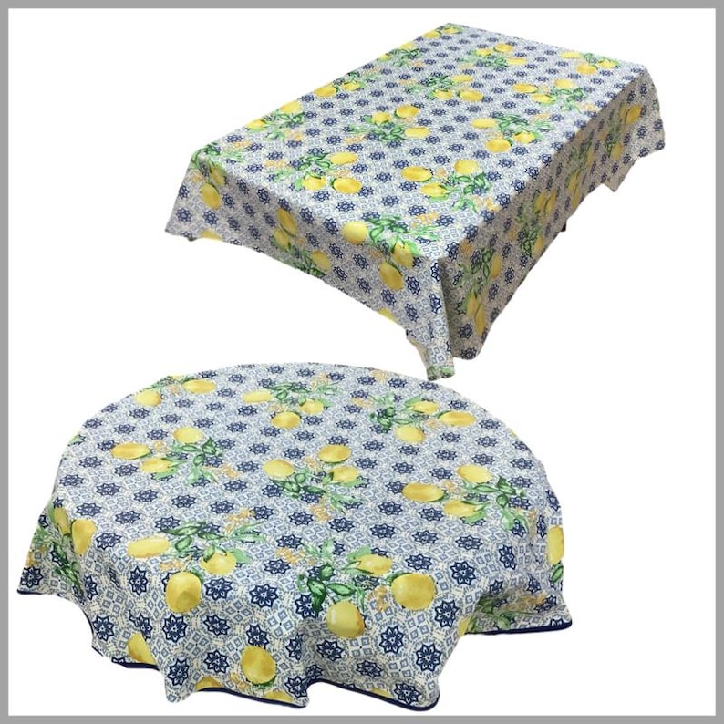 May include: Two tablecloths with a lemon and blue tile pattern. One tablecloth is rectangular and the other is round.