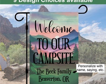 May include: A colorful garden flag with a mountain scene and the text "Welcome to our campsite". The flag is personalized with the text "The Beck Family Beaverton, OR".