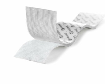 May include: White hook and loop tape with adhesive backing. The tape is folded to show the hook side and the loop side. The tape is labeled "Velcro Brand"