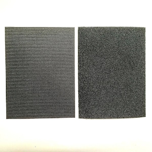 May include: Two black fabric squares, one with a smooth texture and the other with a fuzzy texture. The squares are side by side on a white background.