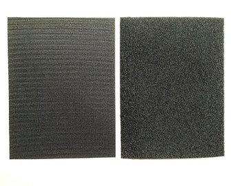 May include: Two black fabric squares, one with a smooth texture and the other with a fuzzy texture. The squares are side by side on a white background.