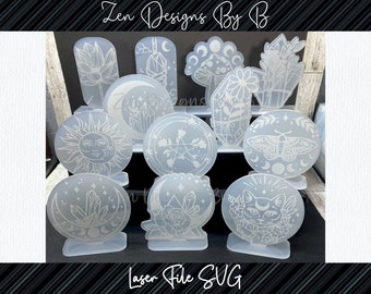 May include: A collection of 10 white, translucent, laser-cut acrylic designs featuring various moon phases, crystals, flowers, and other celestial and nature-inspired motifs. The designs are displayed on a white surface with the text "Zen Designs By B" and "Laser File SVG" visible.