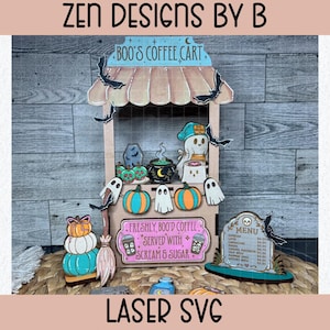 May include: A wooden laser-cut coffee cart display titled Boo's Coffee Cart, featuring a pink sign reading Freshly Boo'd Coffee Served With Scream & Sugar, a menu board, ghost figures, pumpkins, bats, a broom, and a cauldron with green liquid.