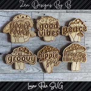 May include: Six wooden mushroom-shaped ornaments with different hippie-themed phrases, including "flower power", "good vibes", "peace", "groovy", "hippie soul", and "stay happy little hippie".