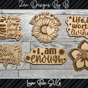 May include: Six laser cut wooden signs with inspirational quotes and floral designs. The quotes include "I am brave, strong, fierce, worthy", "Grow positive thoughts", "Today will be amazing", "I am enough", "Life is worth living", and "Show grace".