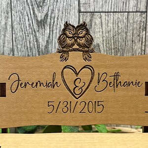 Puede incluir: Un respaldo de silla de boda de madera con una pareja de b&uacute;hos tallados, un coraz&oacute;n con una ampersand, los nombres Jeremiah & Bethanie y la fecha 5/31/2015.