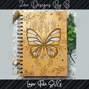 Close-up of detailed butterfly engraving on wood, symmetrical filigree frame, butterfly notebook cover SVG in bundle