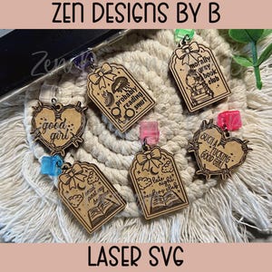 May include: A collection of six laser-cut wooden charms featuring various designs and text including 'probably reading smut', 'morally grey book club', 'good girl', 'read past my bedtime', 'late night readers club', and 'such a fucking good girl'.