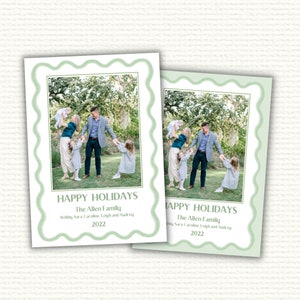 May include: A Christmas card featuring a family of five standing in a grassy field. The family is smiling and holding hands. The card is decorated with a green border and the text "Happy Holidays The Allen Family Bobby, Sara, Caroline, Leigh and Audrey 2022".