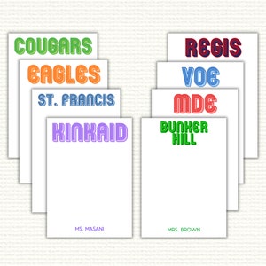 May include: A set of eight personalized note cards with different school names and colors. The names include Cougars, Eagles, St. Francis, Regis, Voe, Mde, Kinkaid, and Bunker Hill. The cards are white with a black border and the names are in a retro font style.