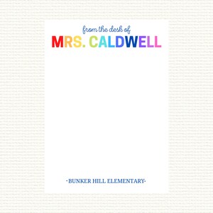 May include: A white note pad with the text "from the desk of MRS. CALDWELL" in rainbow colors and the text "BUNKER HILL ELEMENTARY" in blue at the bottom.