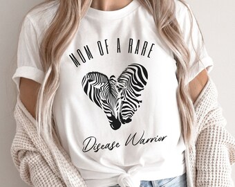 May include: White t-shirt with a black zebra print heart and the text "Mom of a Rare Disease Warrior".