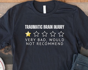 May include: A black t-shirt with a white graphic that says "Traumatic Brain Injury" and has a one-star rating with the text "Very Bad, Would Not Recommend".