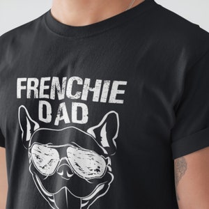 May include: Black t-shirt with white text that reads "Frenchie Dad" and a white silhouette of a French bulldog wearing sunglasses.