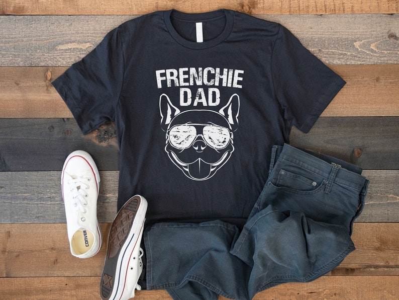 May include: A black t-shirt with a white graphic of a French Bulldog wearing sunglasses and the text "Frenchie Dad".