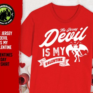 May include: Red t-shirt with a white graphic that says "The Jersey Devil is my Valentine" with a cartoon devil illustration.
