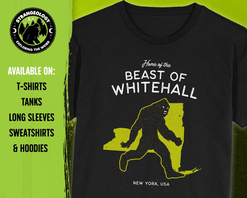 May include: Black t-shirt with a yellow graphic of a Bigfoot-like creature walking across a yellow outline of the state of New York. The text "Home of the BEAST OF WHITEHALL" is above the graphic and "NEW YORK, USA" is below. The text "AVAILABLE ON: T-SHIRTS, TANKS, LONG SLEEVES, SWEATSHIRTS & HOODIES" is on the left side of the image.