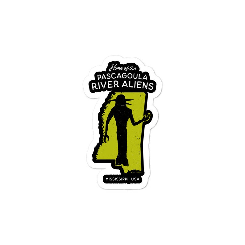 May include: A sticker featuring a black silhouette of an alien with a large head and large eyes, standing in front of an outline of the state of Mississippi. The sticker says "Home of the Pascagoula River Aliens" and "Mississippi, USA".
