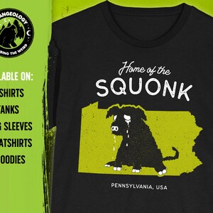 May include: Black t-shirt with a yellow outline of the state of Pennsylvania and a black and white illustration of a crying creature with the text "Home of the SQUONK" and "PENNSYLVANIA, USA".
