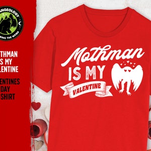 May include: Red t-shirt with a white graphic that says "Mothman is my Valentine" with a drawing of a Mothman and hearts.