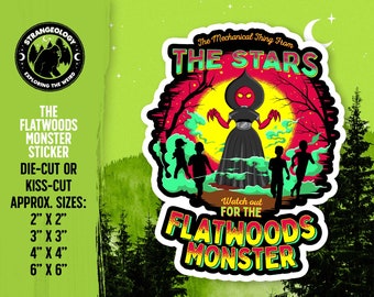 May include: A sticker featuring a red and black alien creature with the text "The Mechanical Thing From The Stars" and "Watch out for the Flatwoods Monster". The sticker is set against a green forest background with a crescent moon in the upper right corner.