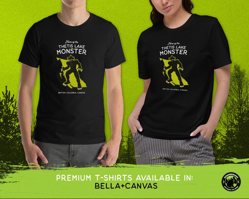 K&ouml;nnte beinhalten: Schwarzes T-Shirt mit einer gelben Grafik eines Monsters, das auf einer Karte von British Columbia, Kanada, steht. Der Text "Home of the Thetis Lake Monster" ist auf dem Shirt aufgedruckt.