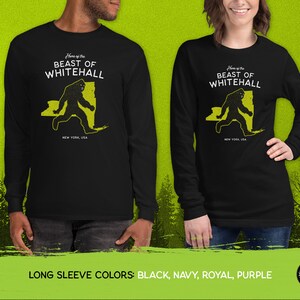 May include: Black long-sleeve t-shirt with a yellow graphic of a Bigfoot-like creature walking across a silhouette of the state of New York. The text "Home of the Beast of Whitehall" is printed above the graphic. The text "New York, USA" is printed below the graphic.