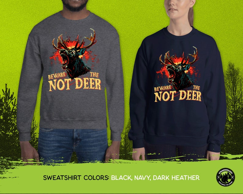 Pu&ograve; includere: Due felpe con una grafica di un cervo con occhi rossi luminosi e il testo "Beware the Not Deer". Le felpe sono disponibili in nero, blu navy e grigio scuro.