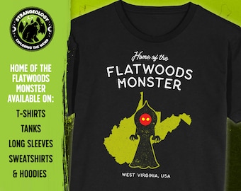 May include: Black t-shirt with a yellow outline of West Virginia and a black silhouette of the Flatwoods Monster with red eyes. The text "Home of the Flatwoods Monster" is printed in white on the shirt. The text "West Virginia, USA" is printed in white at the bottom of the shirt.