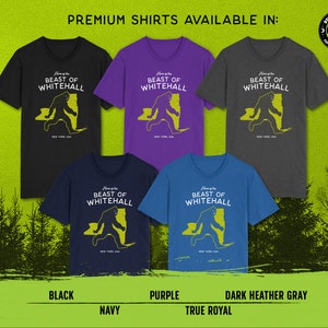 May include: Premium t-shirts featuring a yellow graphic of the Beast of Whitehall, a mythical creature, running across a map of New York State. The shirts are available in black, purple, navy, and dark heather gray.