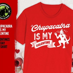 May include: Red t-shirt with a white graphic of a creature with the text "El Chupacabra is my Valentine".