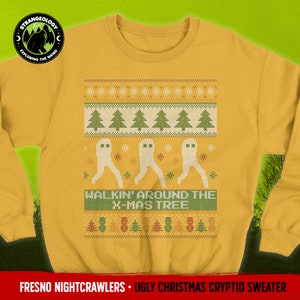 May include: A yellow Christmas sweater with a green and white pixelated design of ghosts walking around a Christmas tree. The text "WALKIN' AROUND THE X-MAS TREE" is printed on the sweater. The sweater is part of the Fresno Nightcrawlers Ugly Christmas Cryptid Sweater collection.