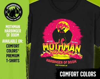 May include: Black t-shirt with a graphic of Mothman, a cryptid with large eyes and wings, in front of a pink and yellow moon. The text "Mothman Harbinger of Doom" is printed below the graphic. The text "Comfort Colors" is printed at the bottom of the shirt.