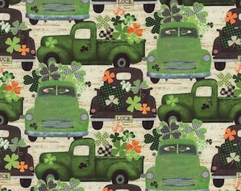 May include: A green and brown patterned fabric with a repeating design of vintage pickup trucks carrying shamrocks and the word "LUCK" on the back.