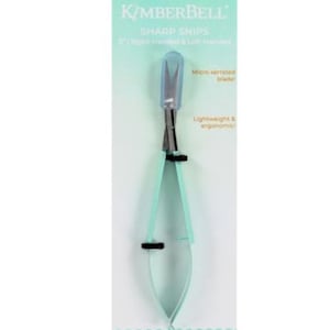 May include: A pair of turquoise blue sharp snips with a micro-serrated blade. The snips are lightweight and ergonomic. The packaging features the text "Kimberbell Sharp Snips" and "Right Handed & Left Handed".