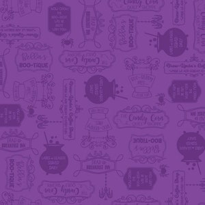 May include: Purple and white patterned fabric with a repeating design of signs and text. The signs feature Halloween-themed text such as "Boo-tique", "Candy Corn", "Brew-Linda's Coffee Shop", and "Lattes & Lizards Served Daily".