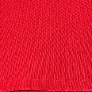 May include: Close-up of a solid red fabric with a textured weave. The fabric has a ribbed hem at the bottom. The color is a vibrant, saturated red.