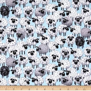 May include: A blue fabric with a repeating pattern of white and gray sheep with black eyes and noses. There are also a few black sheep with curly black wool.