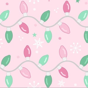 May include: A repeating pattern of pink and green Christmas lights on a light pink background. The lights are strung on a gray wire, with snowflakes and stars scattered throughout the design. The overall theme is festive and holiday-oriented.