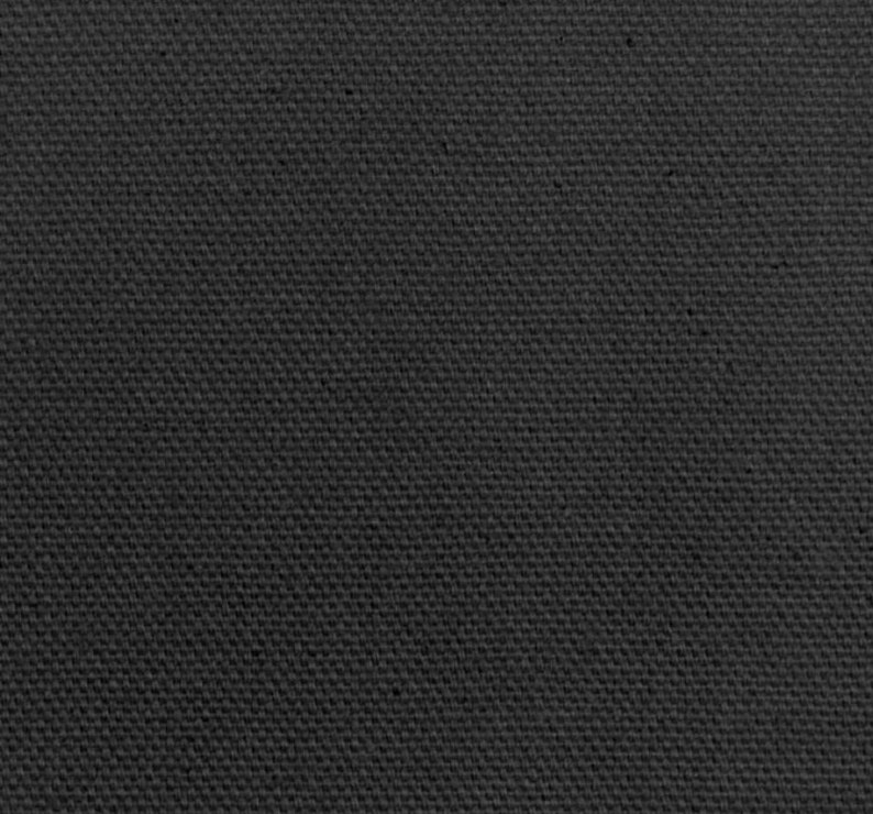May include: A close-up shot of a dark gray canvas fabric. The texture is visible, showing a woven pattern. The material appears to be tightly woven, with a slightly rough surface. The overall tone is a solid, neutral gray.