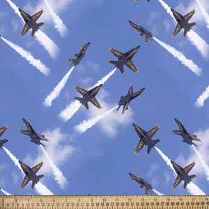 May include: A blue sky with multiple navy blue fighter jets flying in formation, leaving white smoke trails behind them. The jets are labeled with "US NAVY".