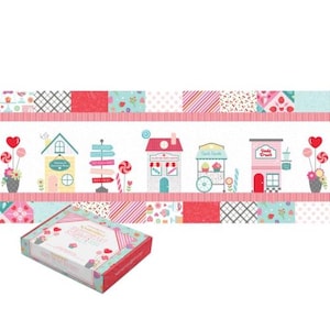 May include: A decorative box with a candy-themed design. The box is light blue with red accents and features a pattern of sweets and houses. The background has a repeating pattern of candy shops and colorful squares. The text on the box reads "KIMBERBELL SWEETHEART STREET".