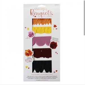 May include: A package of fall-themed pull flowers for crafting. The package includes five different colors of flower shapes: orange, yellow, purple, burgundy, and navy blue. The package says "Kimberbell Bouquets Fall Pull Flowers" and "Create a Handcrafted Bouquet in Seconds".