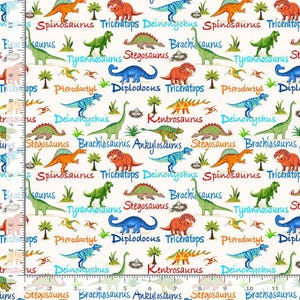 May include: A white fabric featuring a colorful dinosaur pattern. The design includes various dinosaurs like Triceratops, Tyrannosaurus, and Stegosaurus, along with their names in a playful font. The dinosaurs are in shades of green, orange, blue, and red.